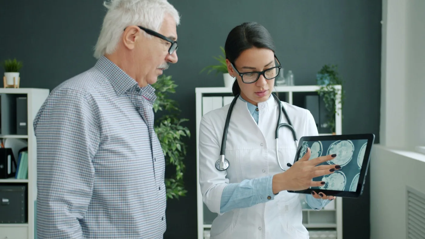 A consultant going through a referral with a patient